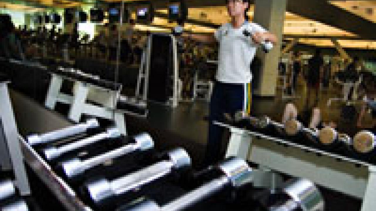 Ahn Thai, on the front, performs capoeira, a Brazilian martial art created by enslaved Africans during the 19th century. She has been practicing capoeira for two years. Martial arts instructor Bob Sarason is in the background wearing black pants
