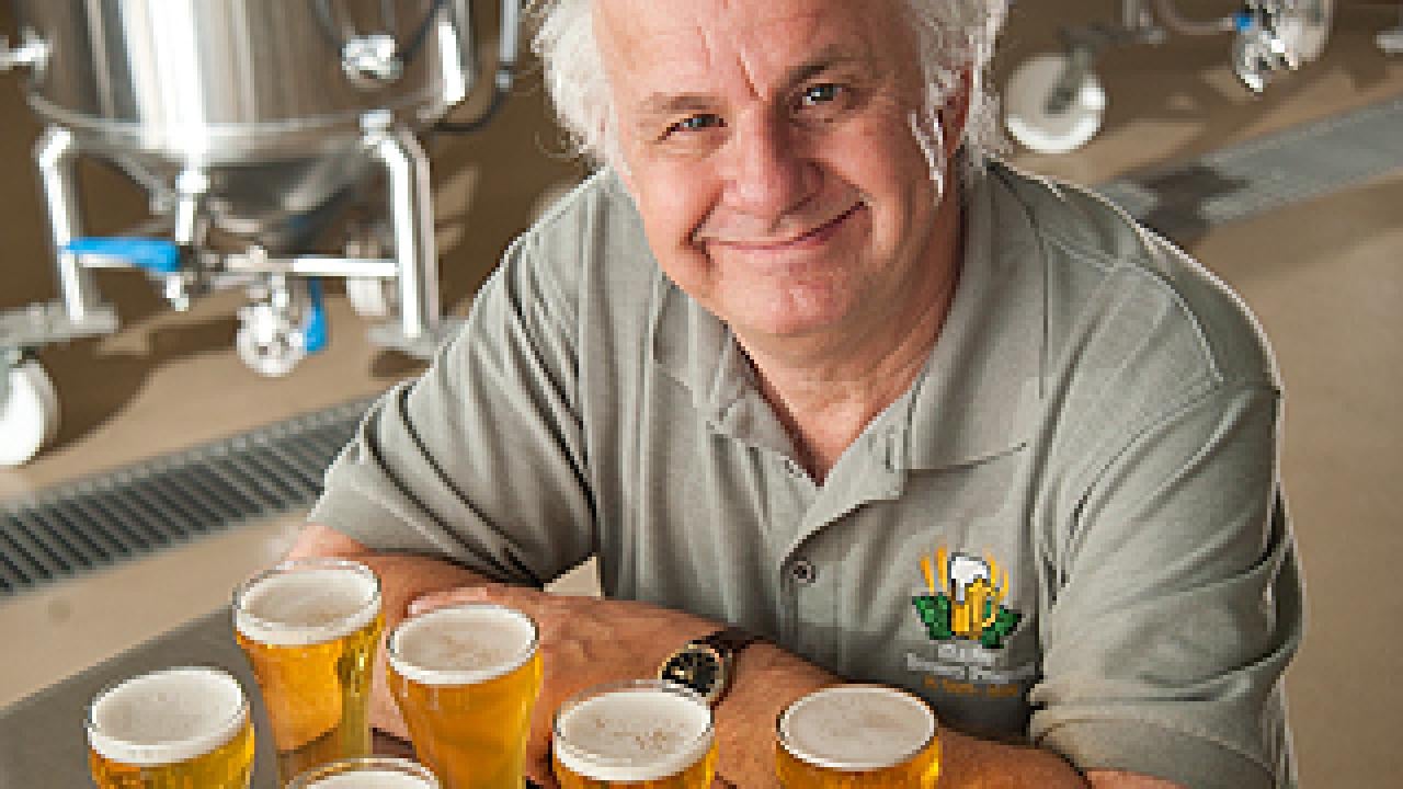 Charlie Bamforth with a number of glasses of beer on a table