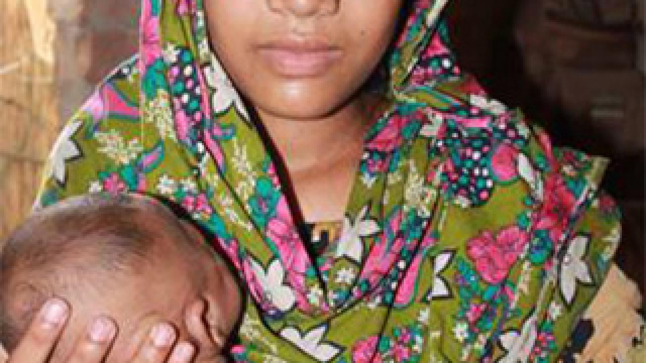 Woman in scarf holding a baby