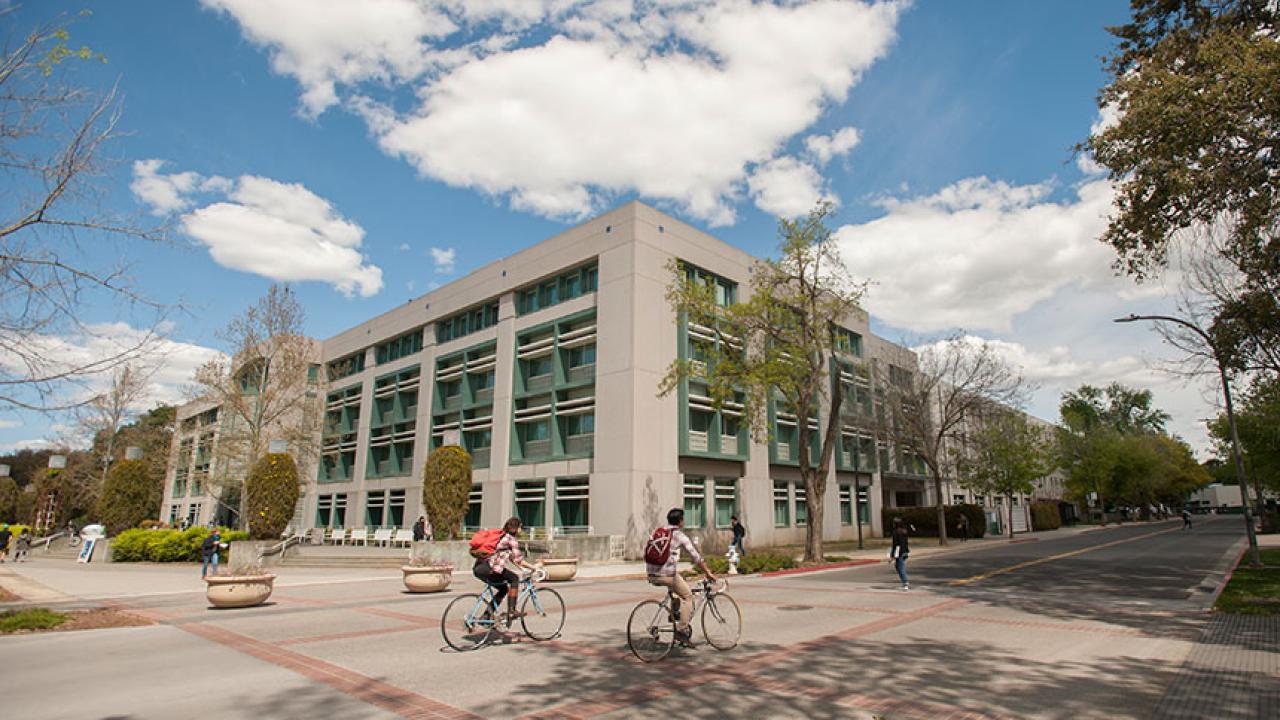 Students bicycle near Shields Library.