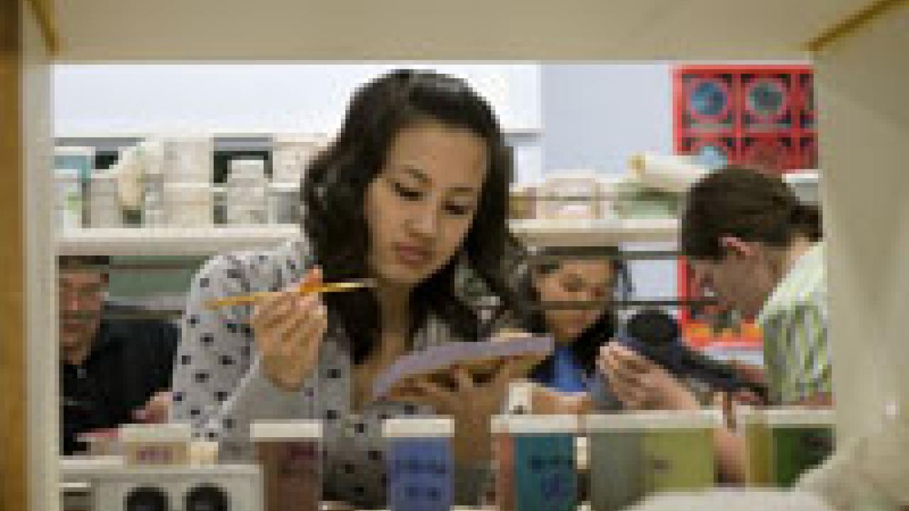 Student Thu Nguyen paints a Jerusalem cricket on ceramic tile for the Nature&rsquo;s Gallery exhibit.