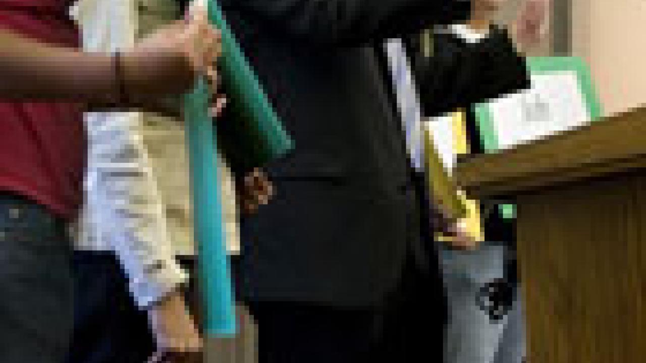 With protesters behind him, Chancellor Larry Vanderhoef speaks to the crowd at the May 3 brown bag chat.