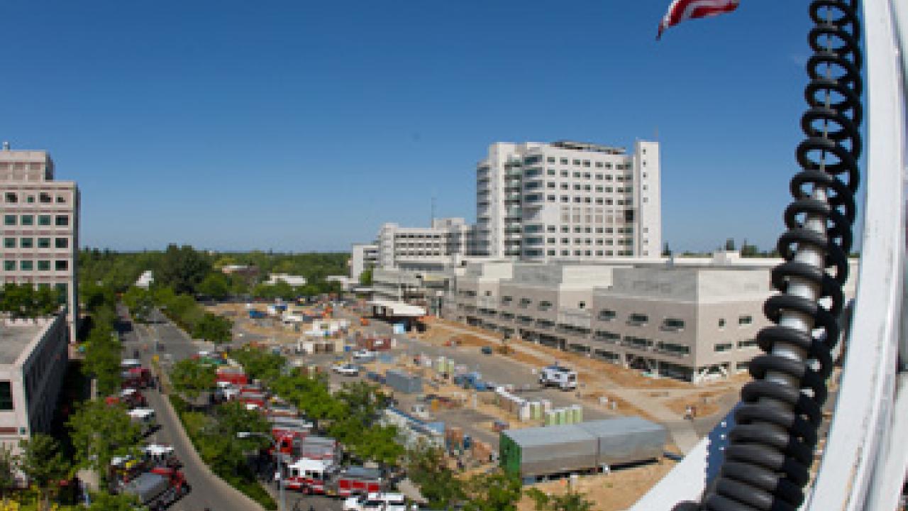 U.S flag hangs from a ladder extended from a firetruck at Burn Brigade 2009. Dozens of firetrucks are pictured below.