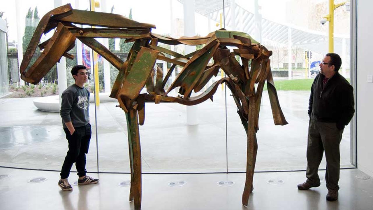 Father and son admire Butterfield horse sculpture in Manetti Shrem Museum.