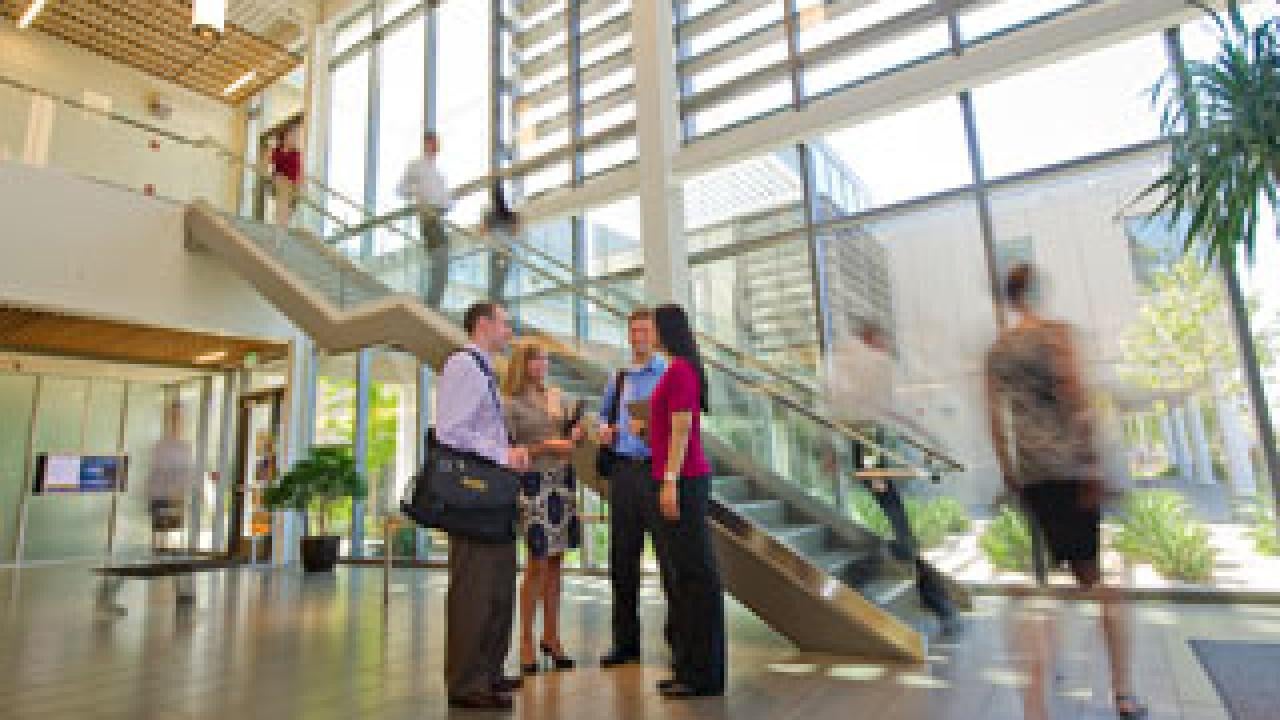 students walking through gallagher hall at UC Davis' graduate school of management