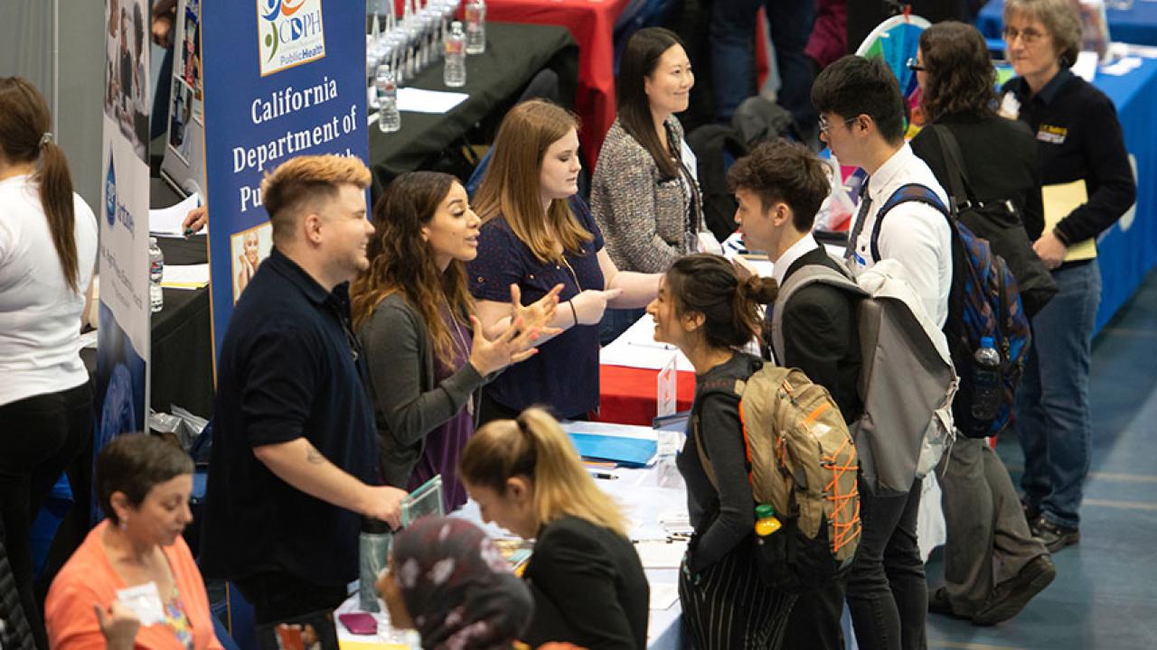 Students talk with employers at career fair