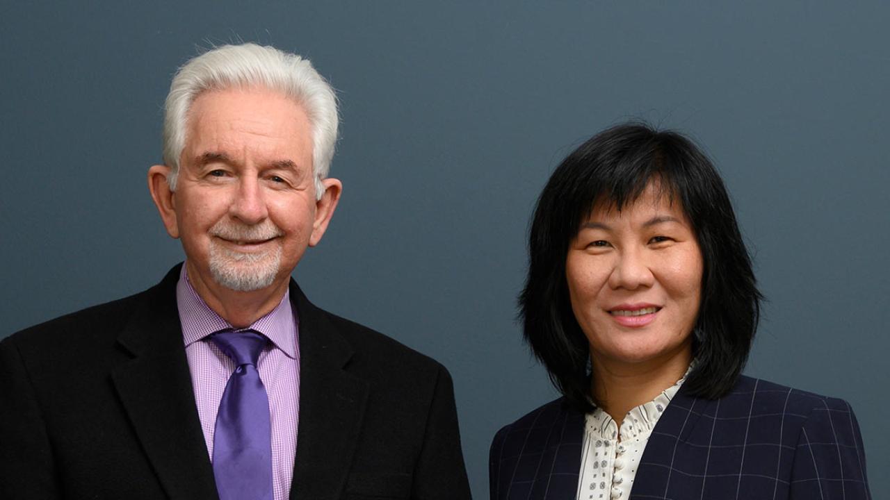 Cameron Carter and Li Tian, side by side in environmental portrait