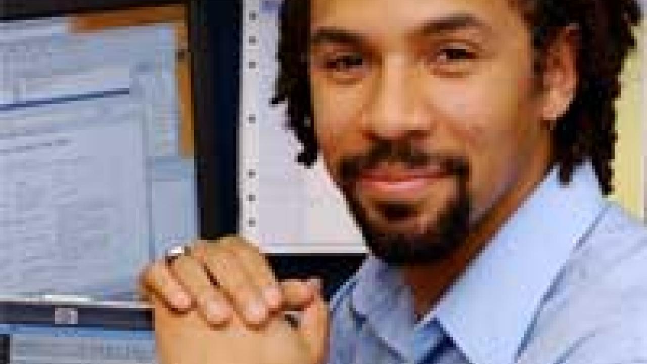 Photo: man's portrait with computer