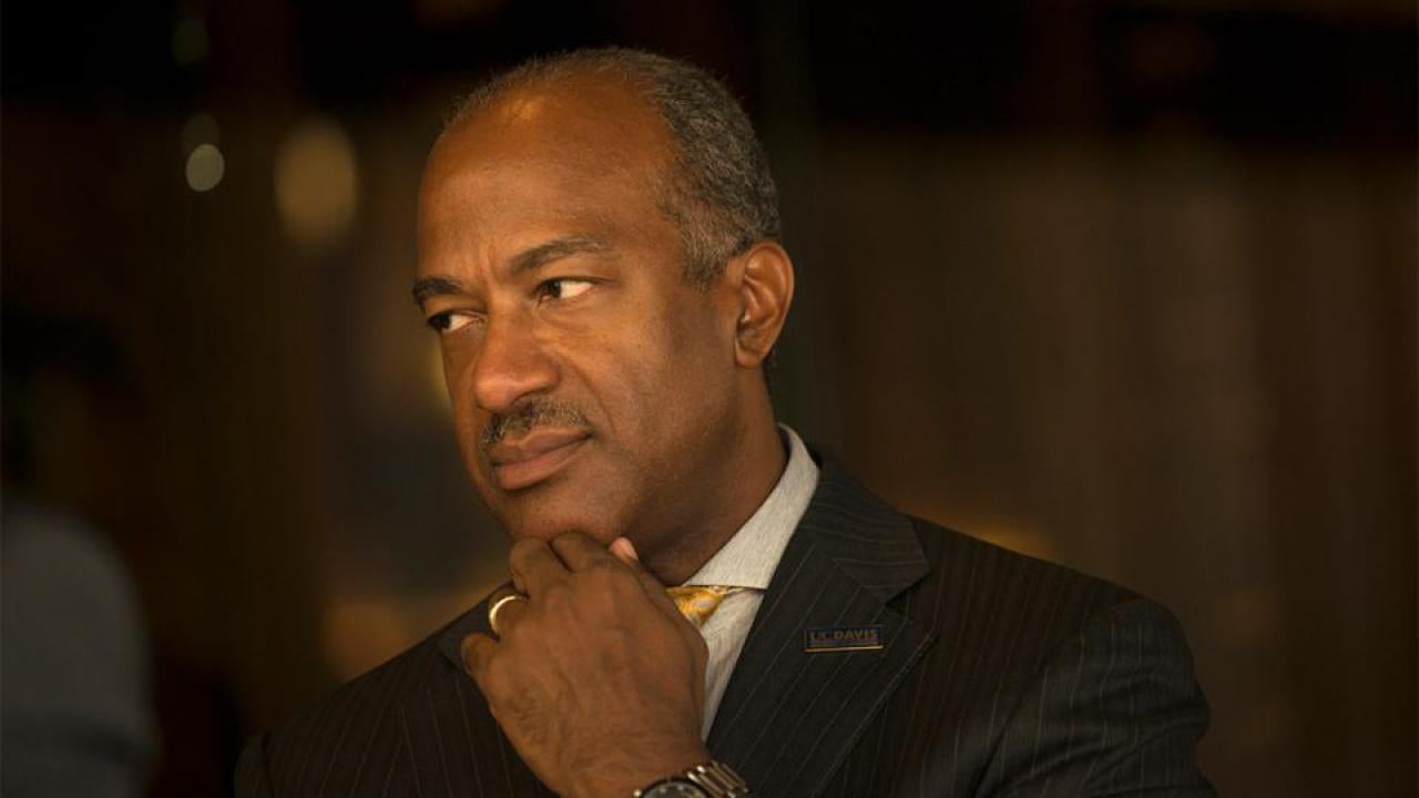 Chancellor May rest chin on hand.