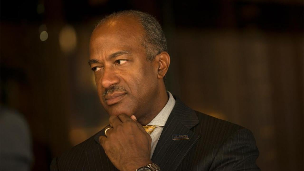 Chancellor Gary S. May, chin in hand