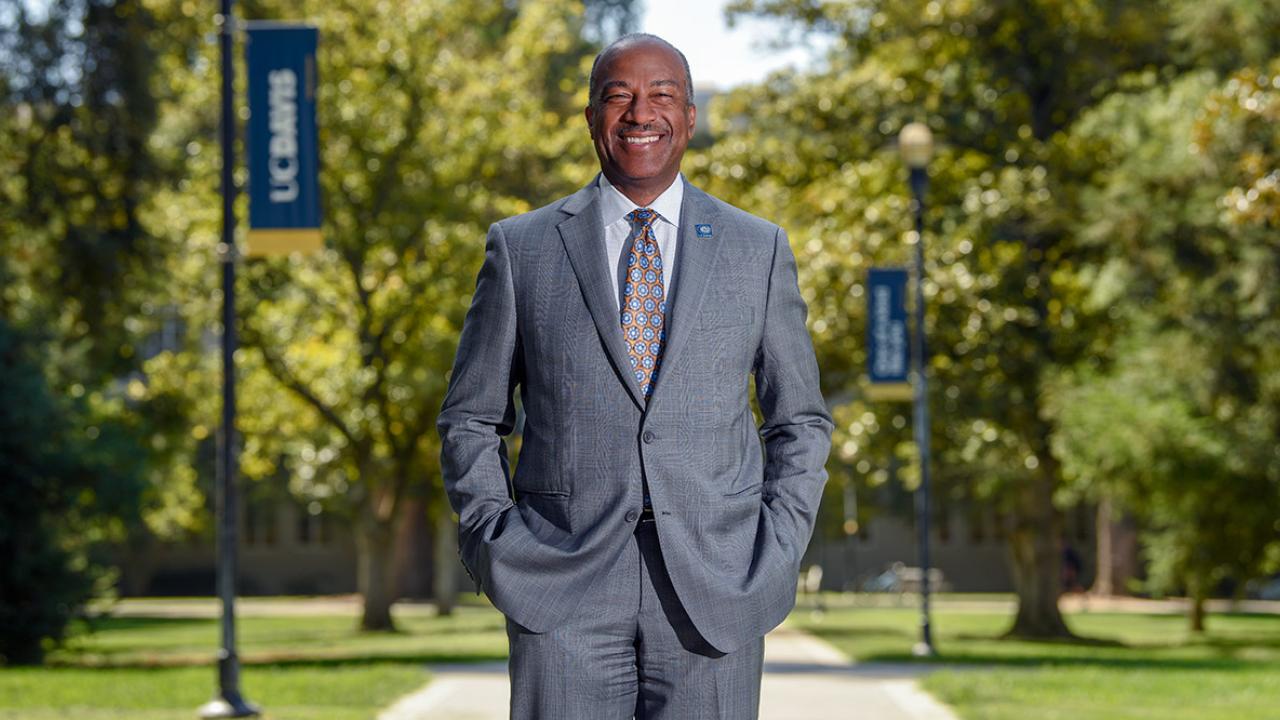 Chancellor Gary S. May stands on Centennial Walk. 