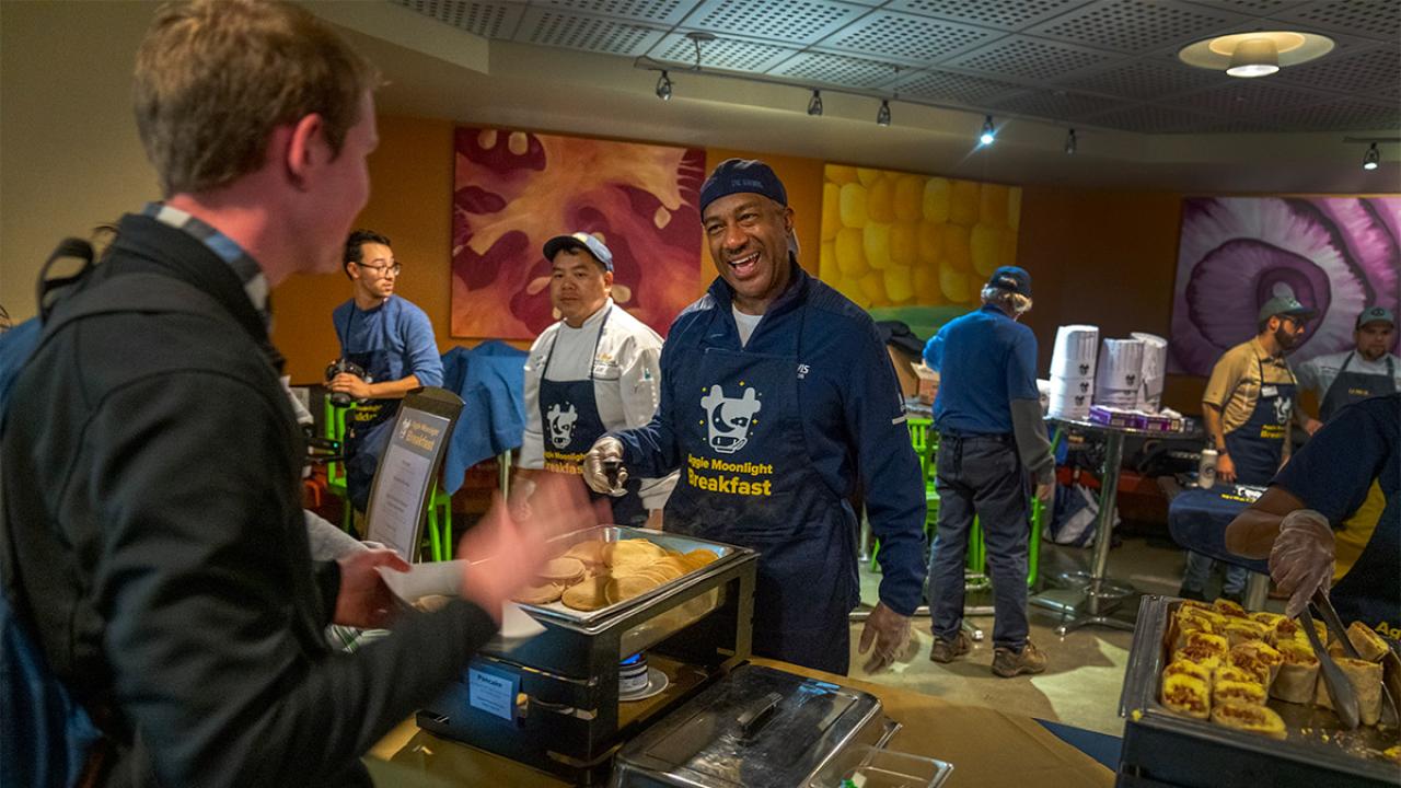 Chancellor Gary S. May serves breakfast to students.