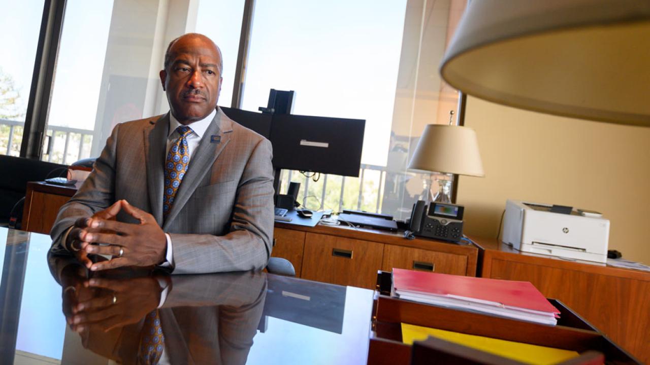 Photo of the chancellor at his desk.