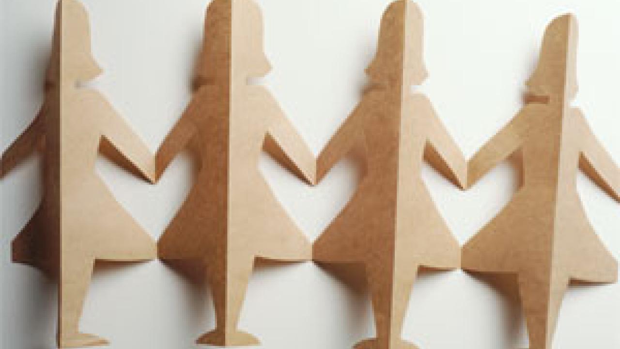 Photo: four female paper doll cutouts