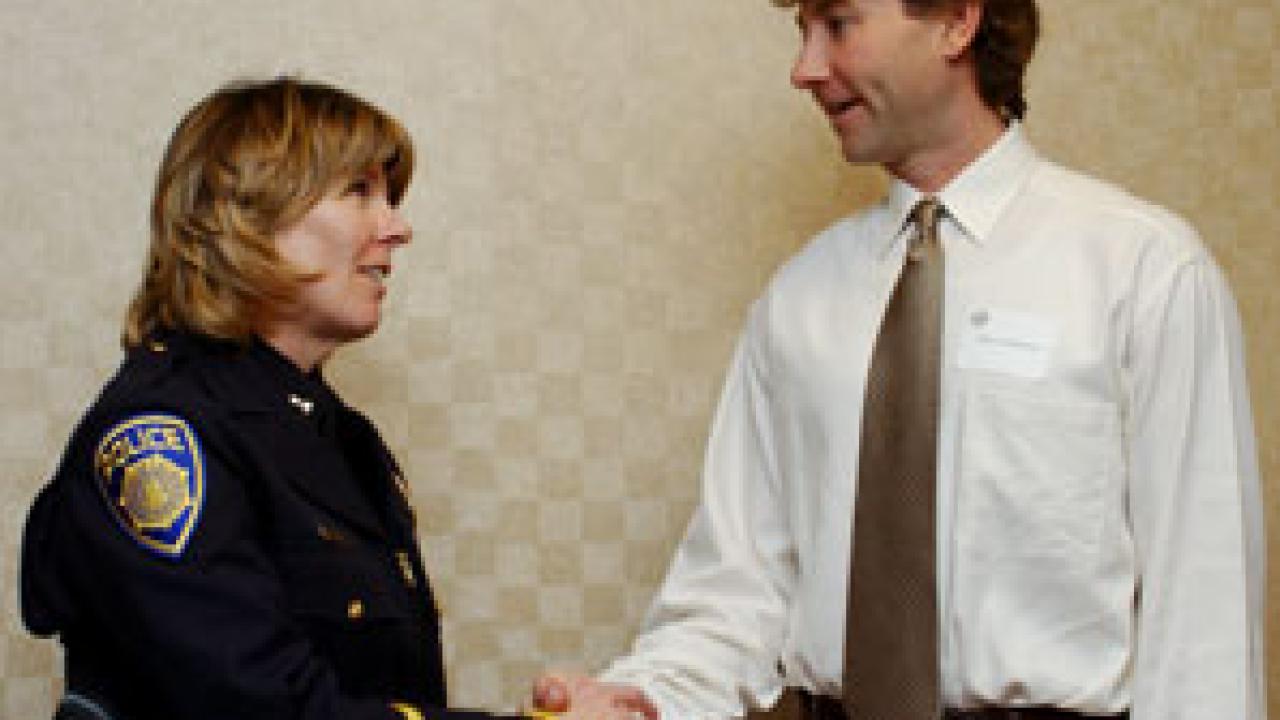 Capt. Leslie Brown thanks Peter Anderson for helping out after a shooting on campus in December.