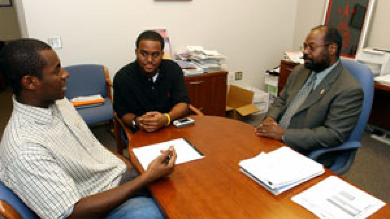 LeVale Simpson,  middle, talks about student-community relations issues with ASUCD Sen-ator Caliph Assagai, left, and Rahim Reed, of the Office of Campus-Community Relations. 