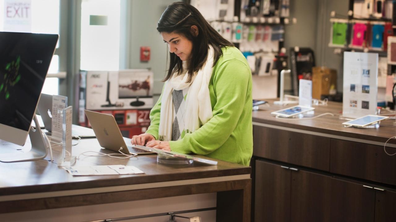 A student shopping for a laptop computer.