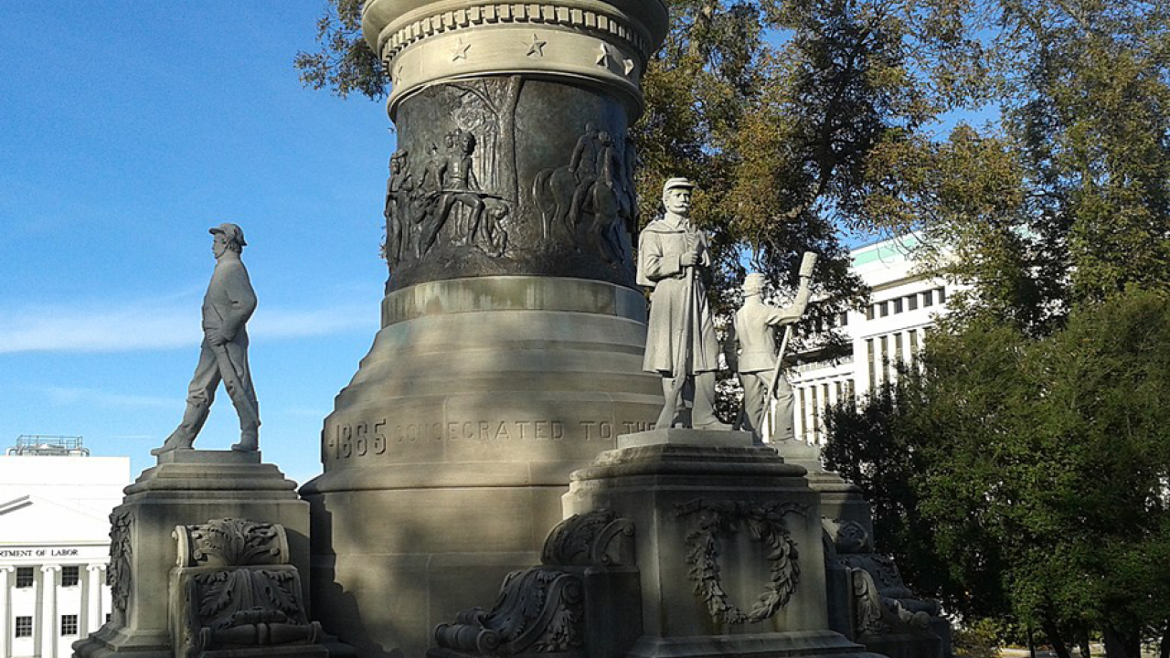 Massive memorial, with a soldier among the figures around the base
