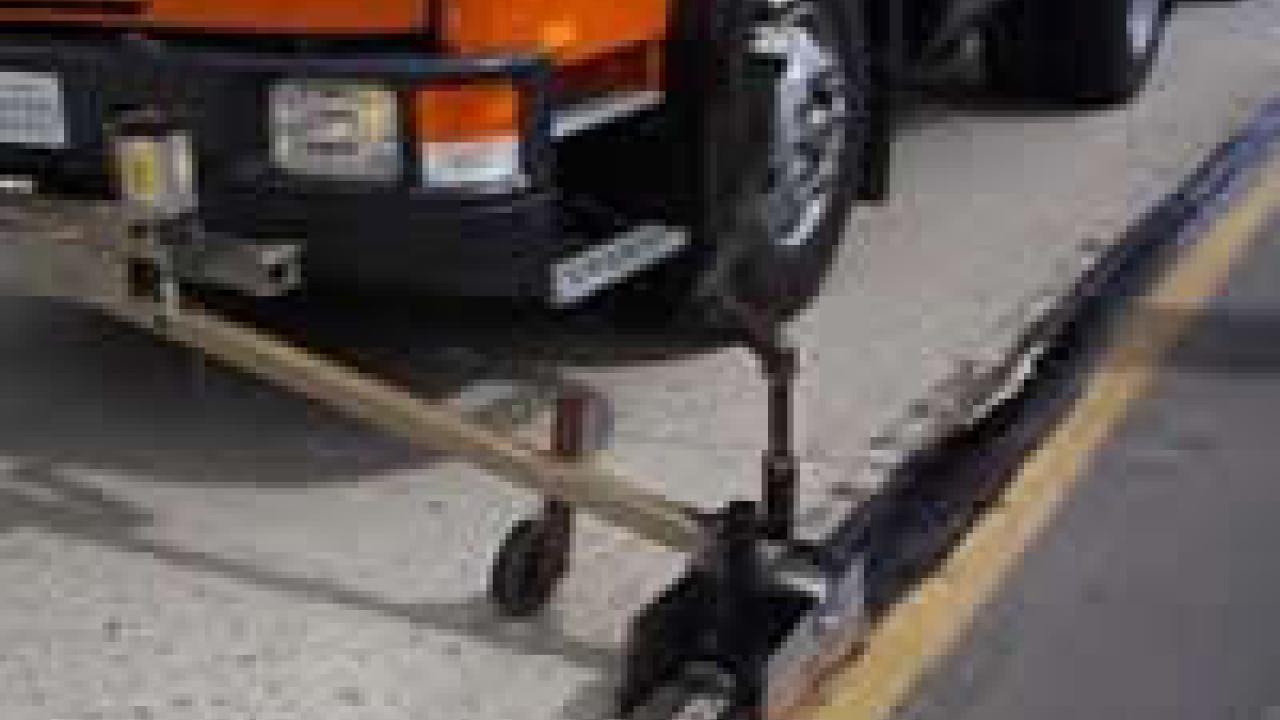 photo: truck with equipment sealing crack in road