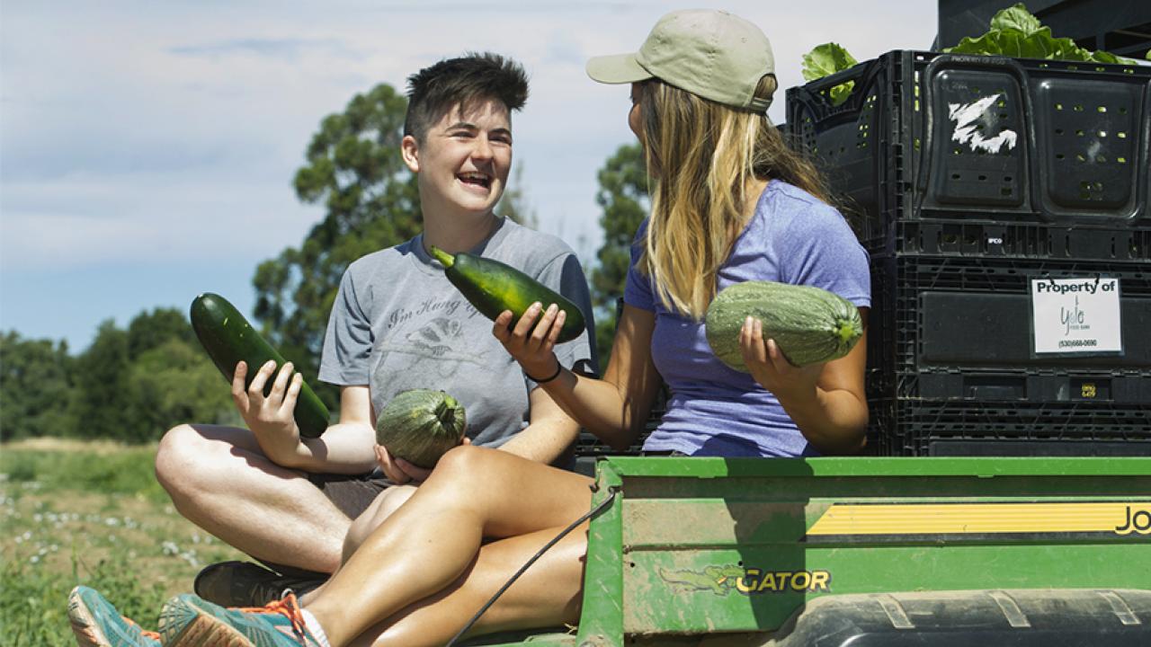 Two female students with produce