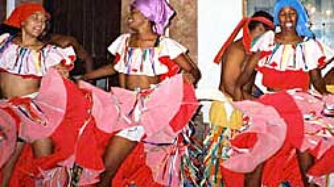 Photo: Three women in costume dancing, holding skirts up