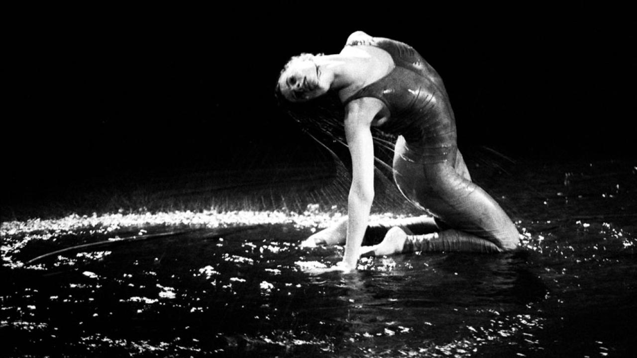 Dancer in a pool of water, on stage