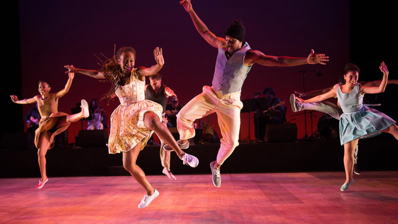 Dorrance dancers jumping on stage.