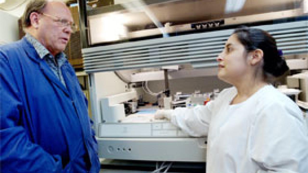 The director of the Center for Vectorborne Diseases, John Edman, talks with staff research associate Nicole Kahl, who&rsquo;s been working with samples of RNA from birds to help keep tabs on West Nile virus. The center has confirmed the presence of 