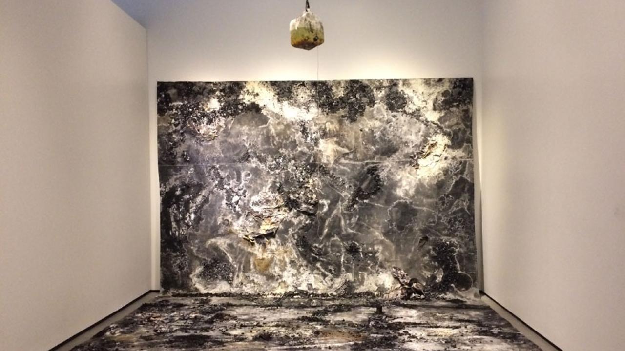 "Glass Mountain" from floor to wall, with container suspended overhead.