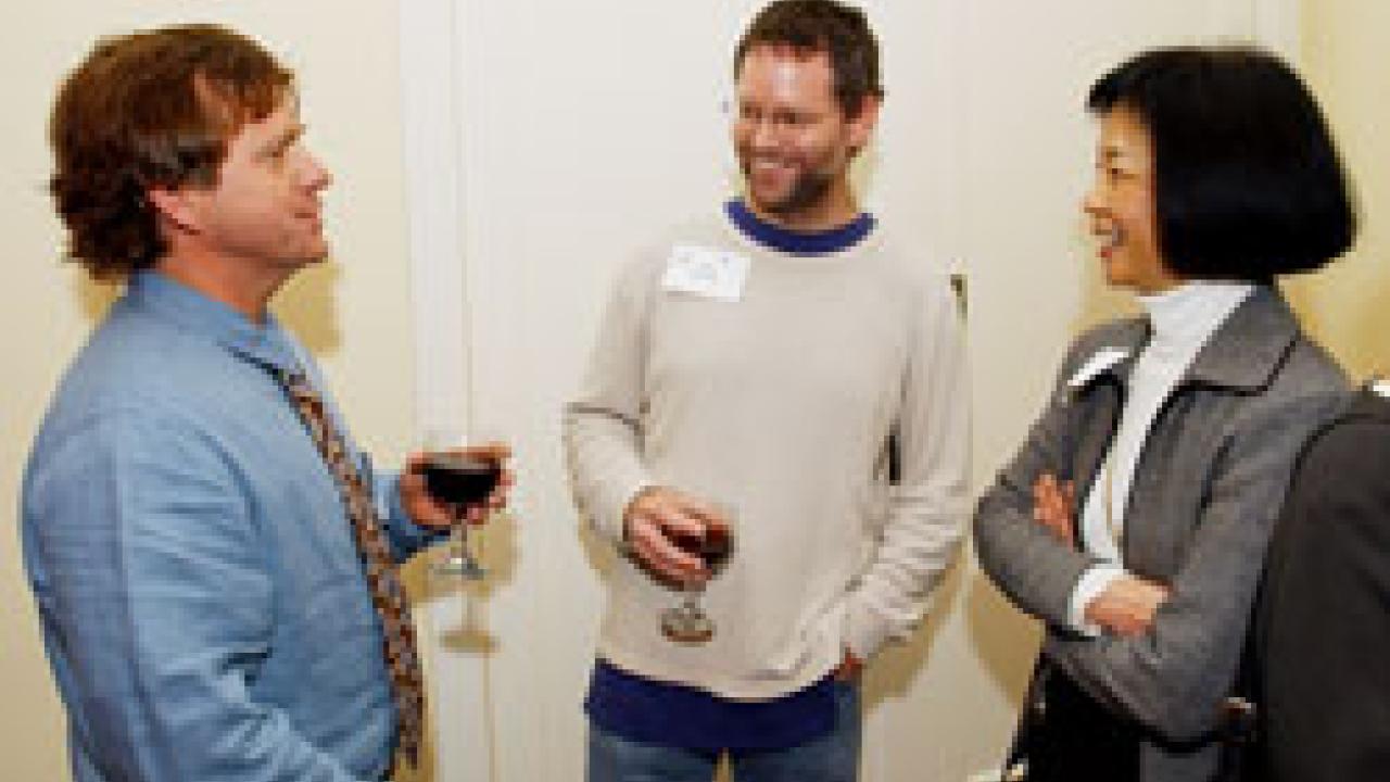 New fellows Mark Schwartz, left, and John Bowman talk with Division of Biological Sciences Dean Phyllis Wise. 