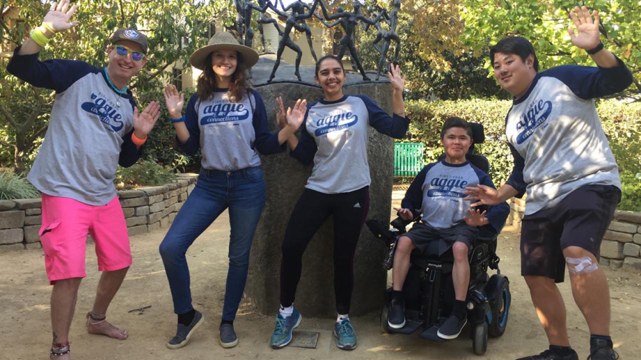 Facilitator and First-Year Aggie Connection students, striking fun poses around fun scultpture of little people in fun poses.