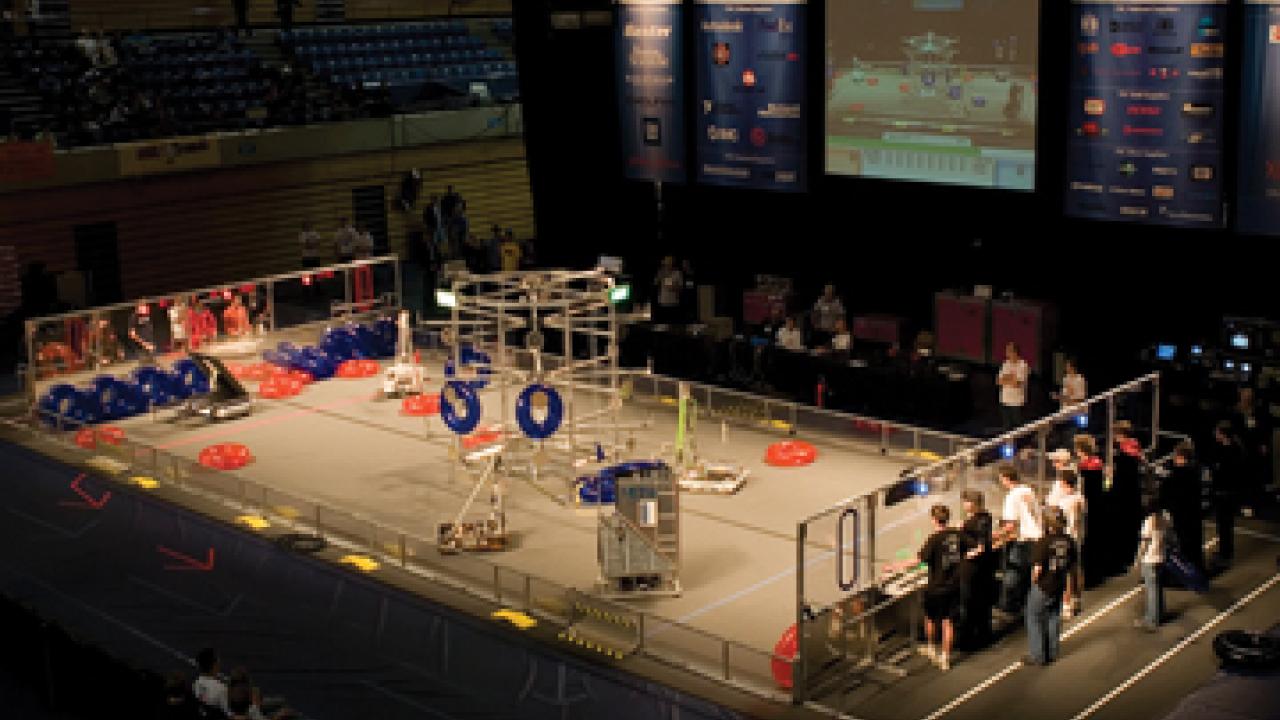 Robots in the ARC arena, playing three-dimensional tic-tac-toe with red and blue inner tubes.