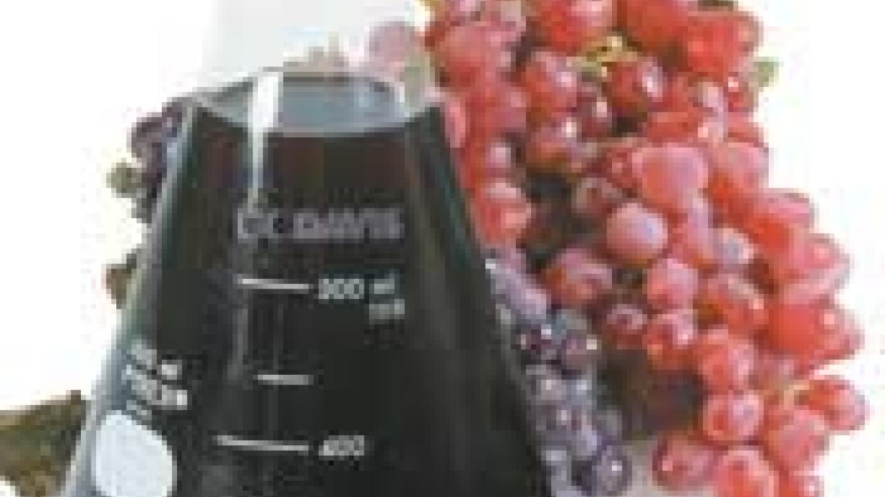 photo: flask of wine with grapes in background