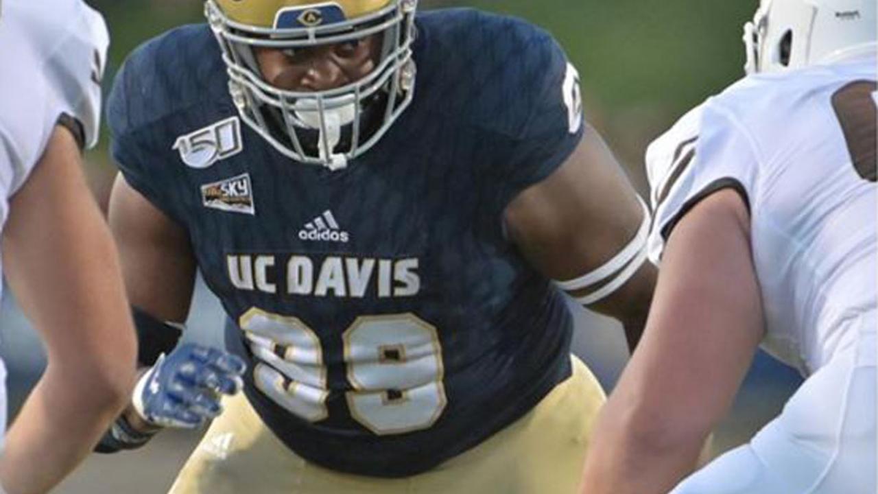 Aggie football player stares down opponent.