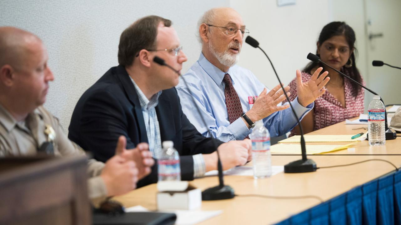 Speakers seated at a table.