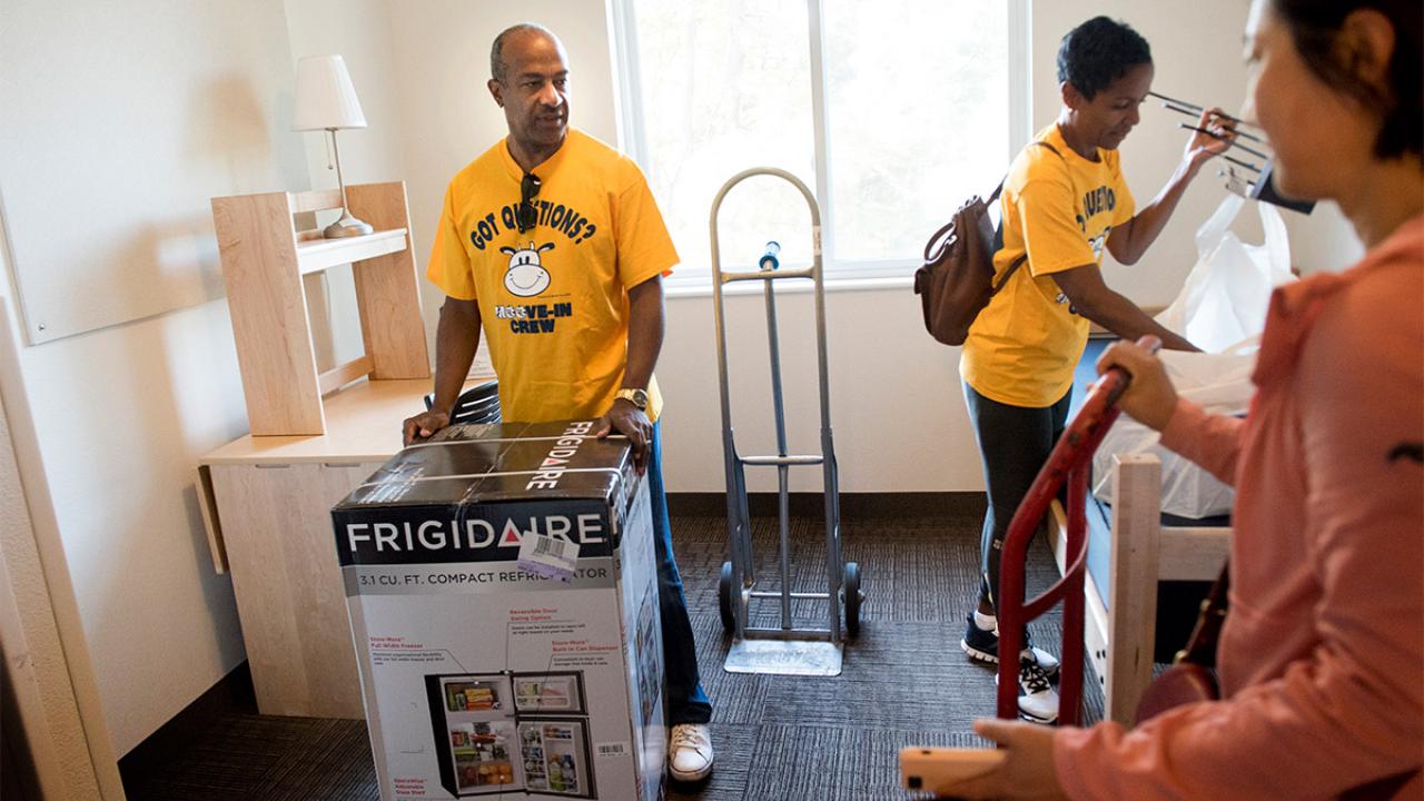 Gary May helping to move a mini-fridge.
