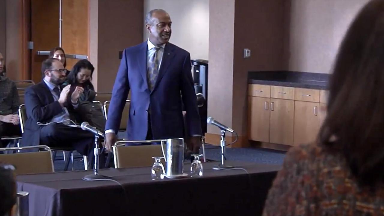 Gary S. May enters the UC regents meeting.