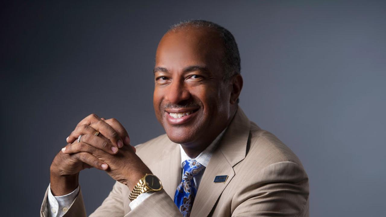 Chancellor Gary S. May, portrait, smiling, hands clasped