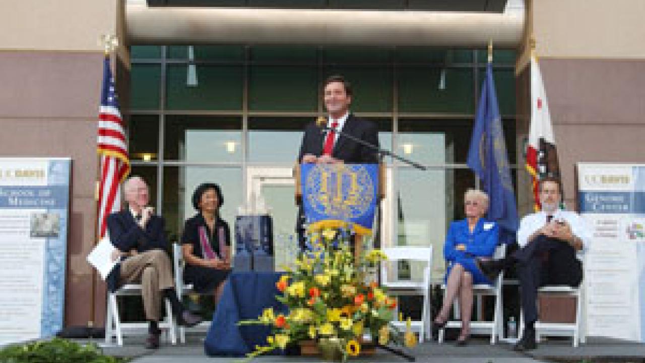 John Garamendi, now California State Insurance Commissioner, speaks to the building dedication audience as other key players in the development of the Genome and Biomedical Sciences Facility, from left, Chancellor Larry Vanderhoef, Phyllis Wise,