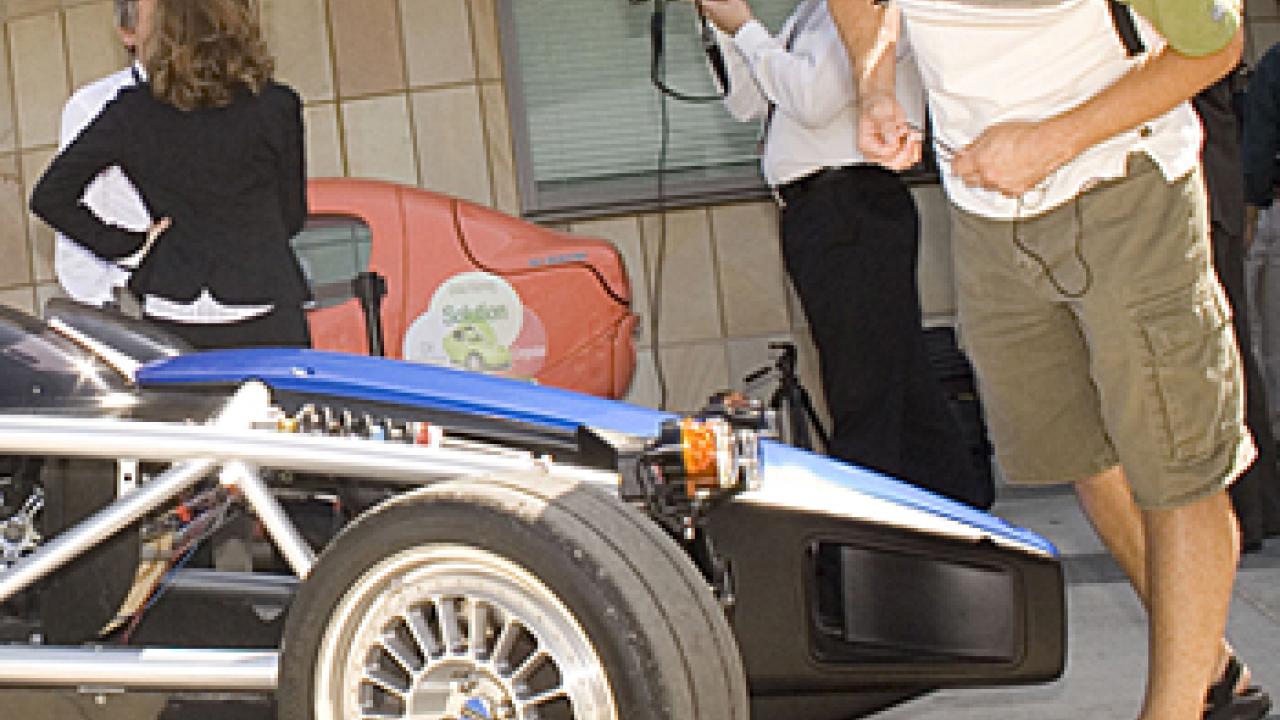 Photo: Man leaning over chassis of car