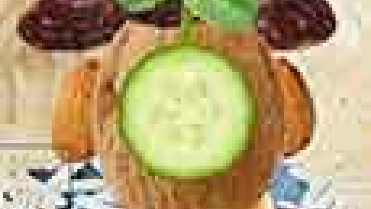 Painting: Maria Robles Gonzalez collage (cropped), showing man with a head of walnut and a cucumber slice in front of his "face"