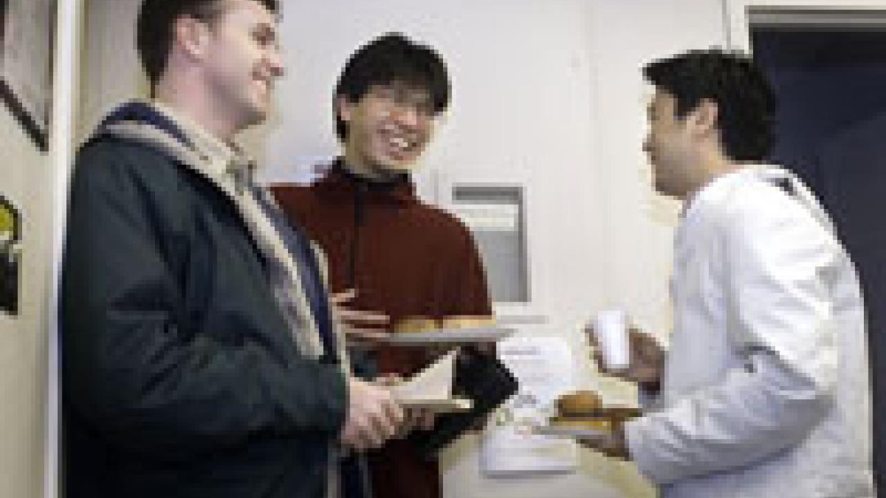 Left to right: Matt Caldwell, a graduate student in the Institute of Transportation Studies, and Ray Tang and Hyung Chul Yoong, both graduate students in mechanical engineering, enjoy a donut-laden, coffee-indulgent conversation Feb. 9 in the So