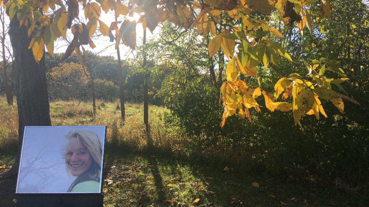 Photo: Fall scenary with photo of Sharon Gray, on easel, in foreground.