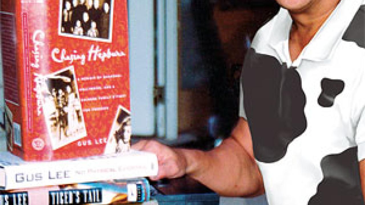 Photo: Man sitting with five books