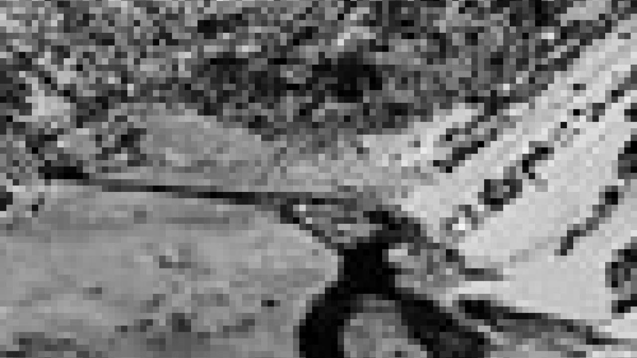 Photo; black and white view of valley, stream and mountains