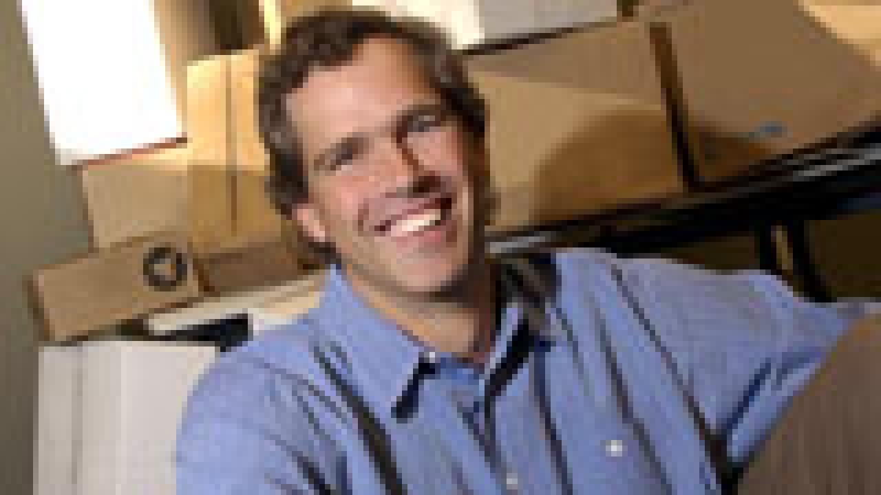 Photo of Andrew Hargadon in a box with many boxes behind him.