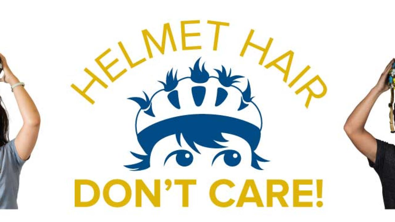 Students posing with their bicycle helmets.