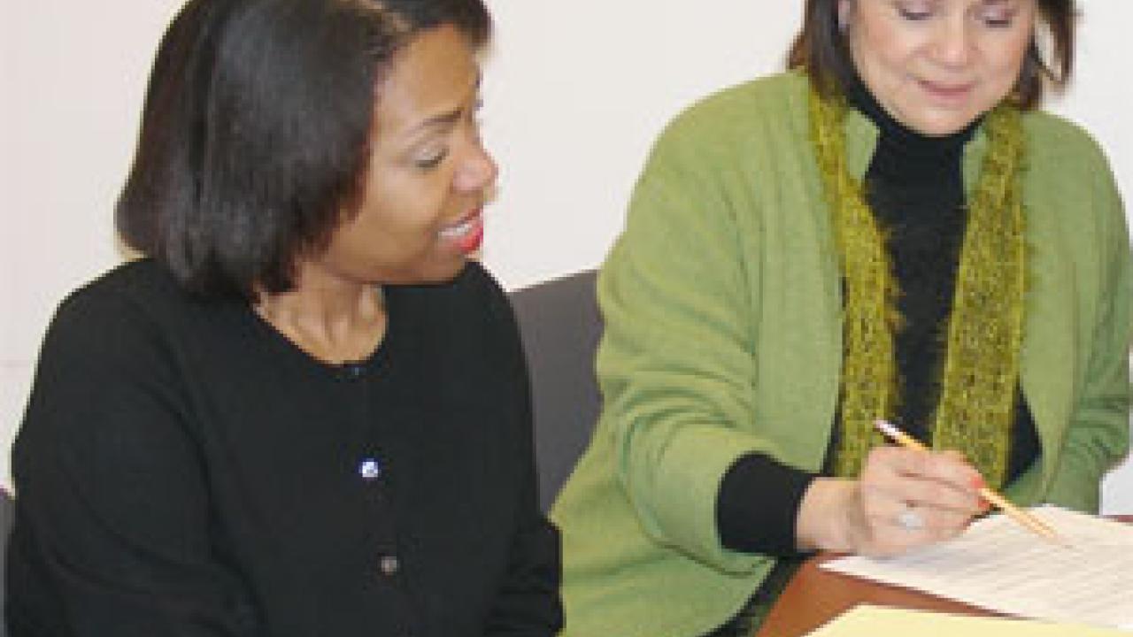 Staci Bates, left, consults with Ellie Sandoval, Bate&rsquo;s supervisor while she is taking part in a pilot internship program in human resources.