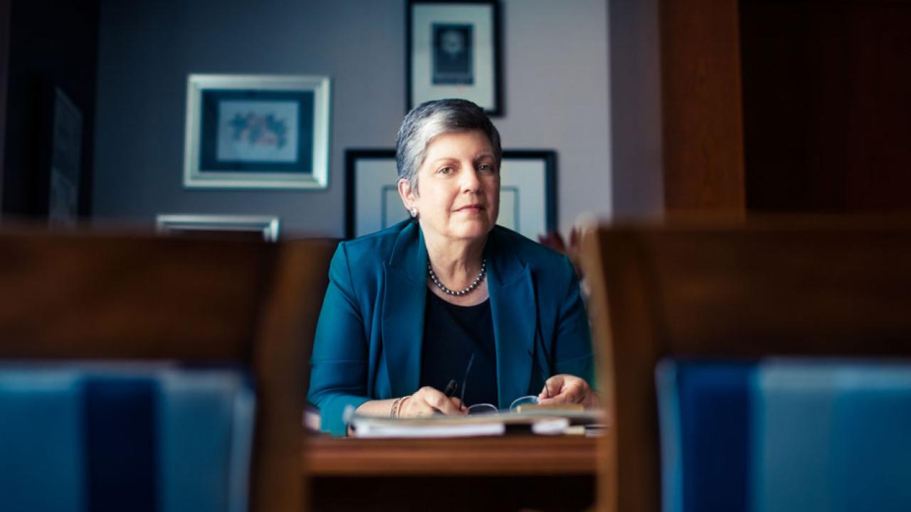 Janet Napolitano behind desk