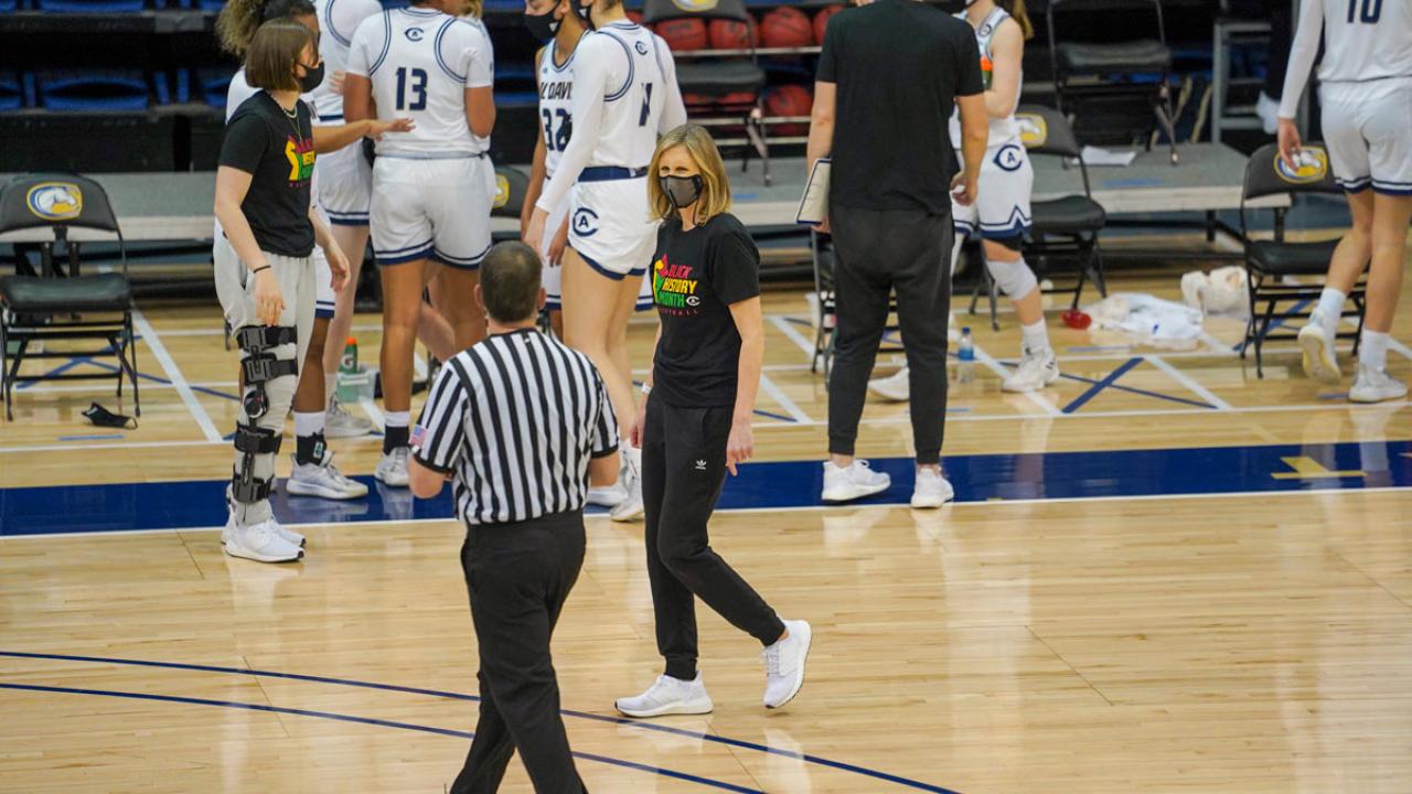 Coach "chats" with referee on court.